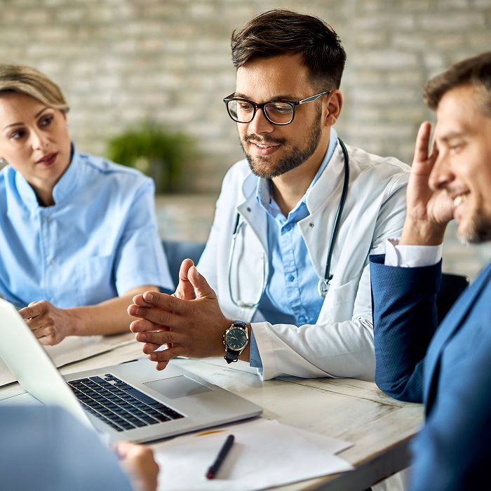 Medical team and financial consultant discussing bookkeeping reports