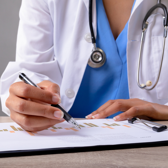 Medical professional checking financial recordkeeping report