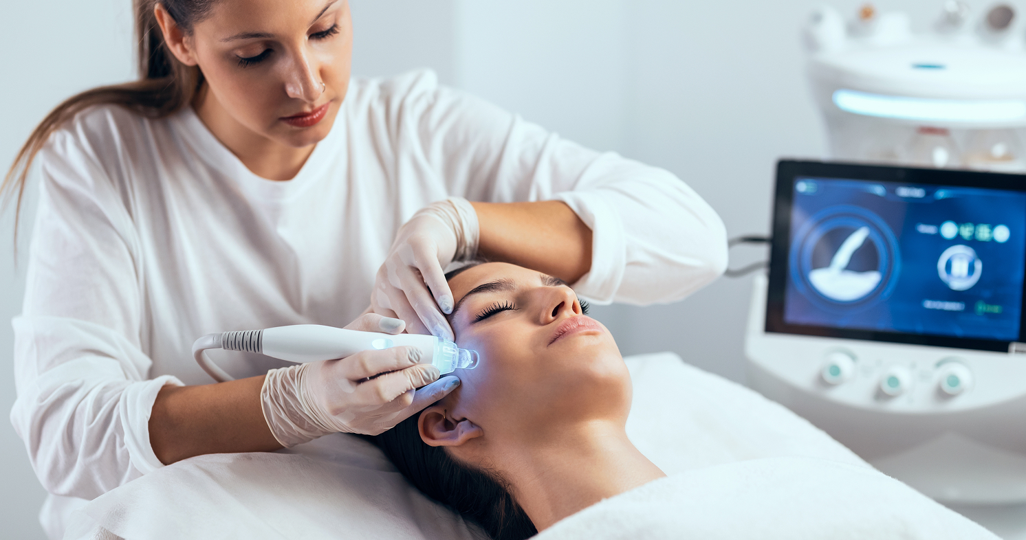 Cosmetologist performing ultrasonic facial treatment at med spa