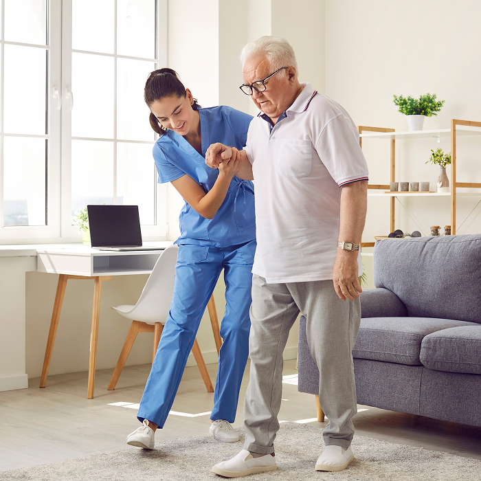 Nurse helping elderly patient walk with care and compassion