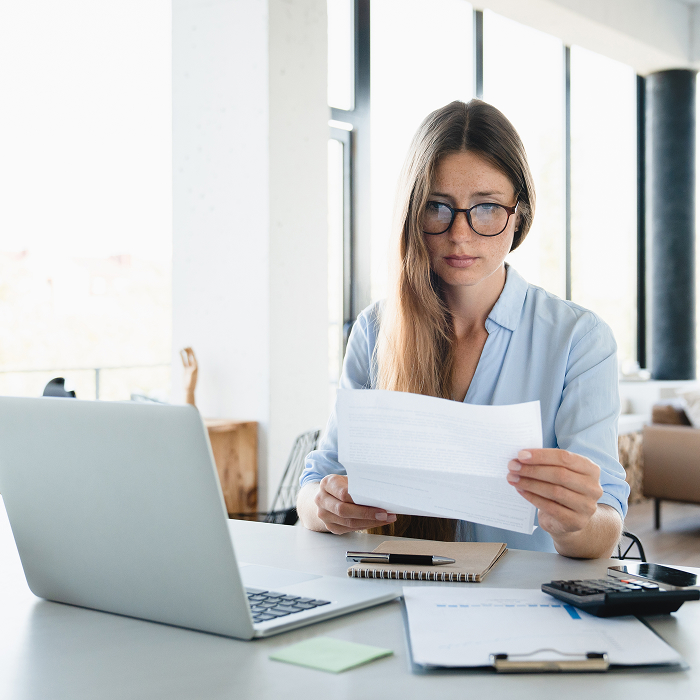 Young woman reviewing invoice for bill payments